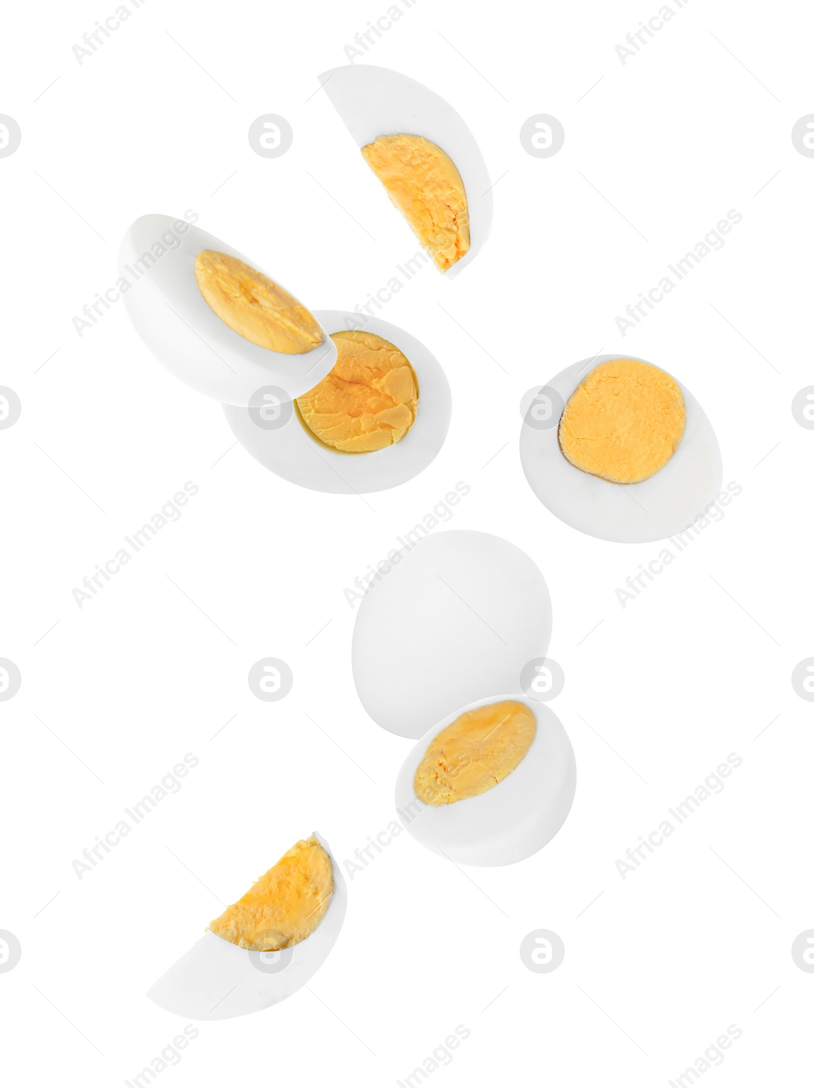 Image of Tasty hard boiled eggs falling on white background