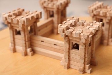 Photo of Wooden fortress on table, closeup. Children's toy