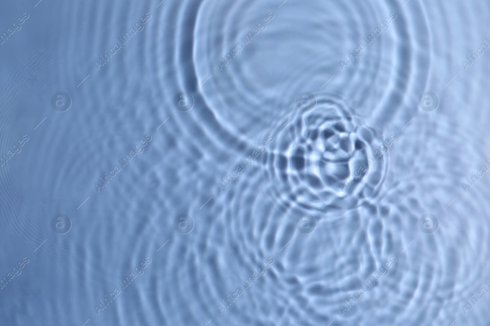 Photo of Closeup view of water with circles on blue background