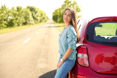 Photo of Young woman near car outdoors on sunny day