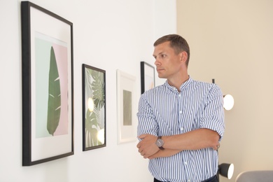 Handsome man at exhibition in art gallery