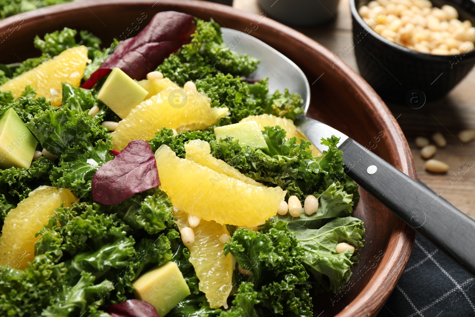 Photo of Tasty fresh kale salad on table, closeup