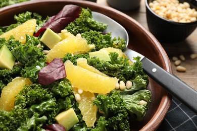 Photo of Tasty fresh kale salad on table, closeup