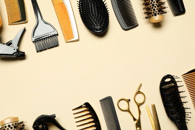 Photo of Hairdressing tools on beige background, flat lay. Space for text