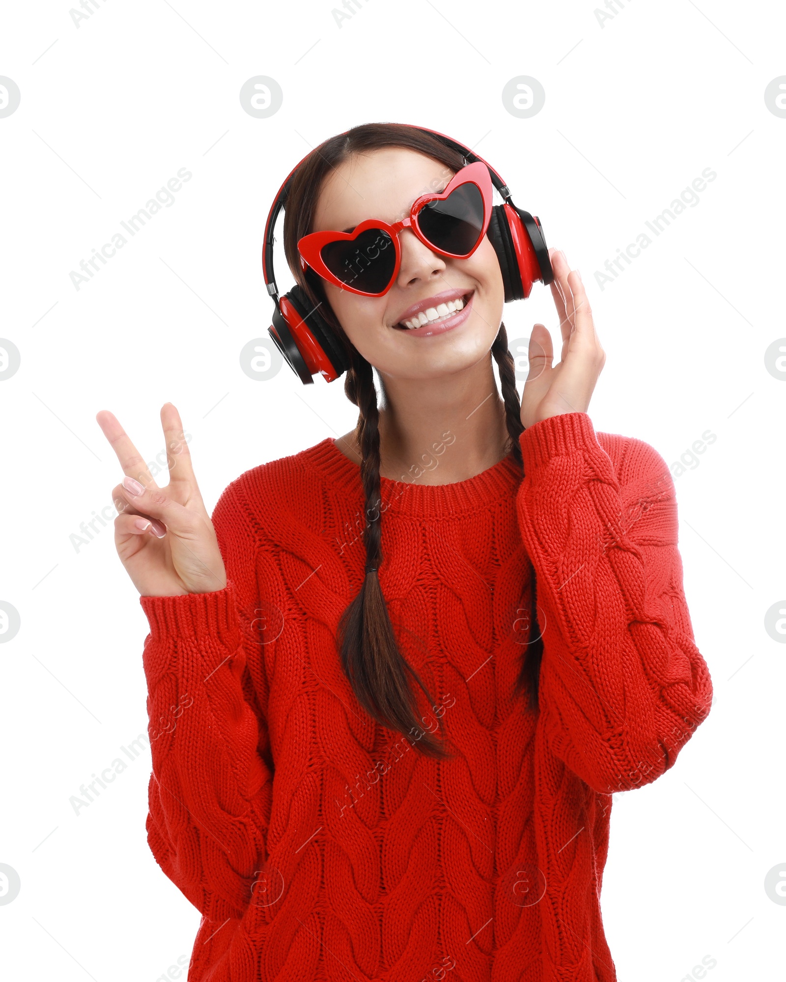 Photo of Young woman wearing heart shaped glasses listening to music on white background