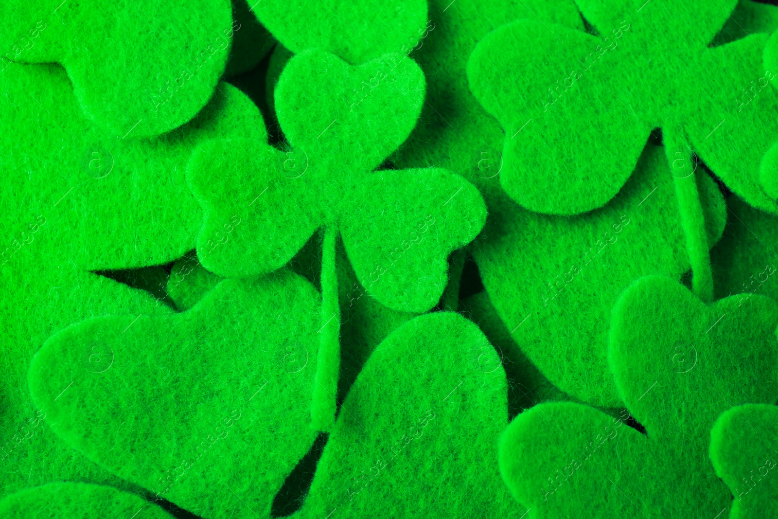 Photo of Green clover leaves as background, top view. St. Patrick's Day celebration