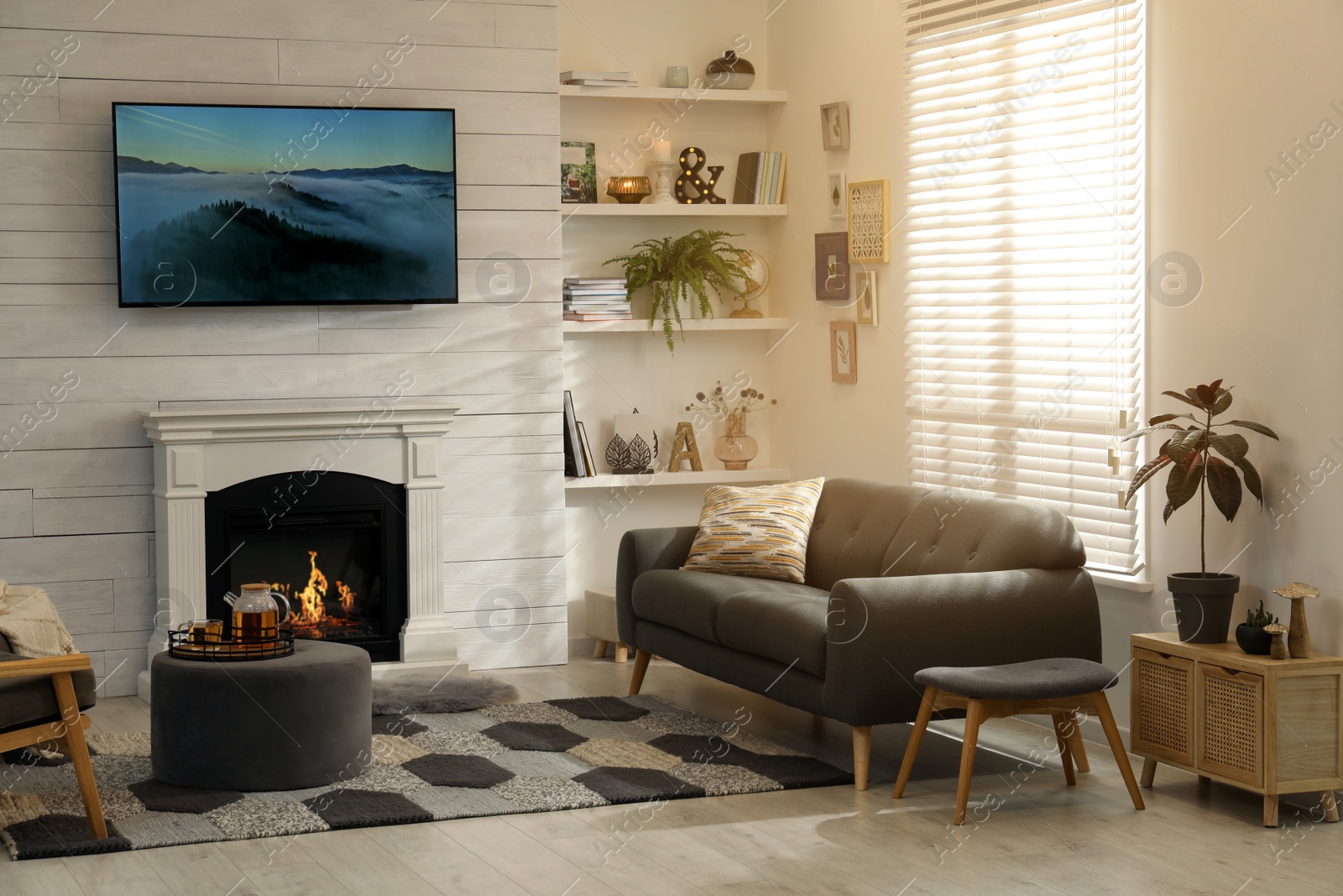 Photo of Cozy living room interior with comfortable sofa and decorative fireplace