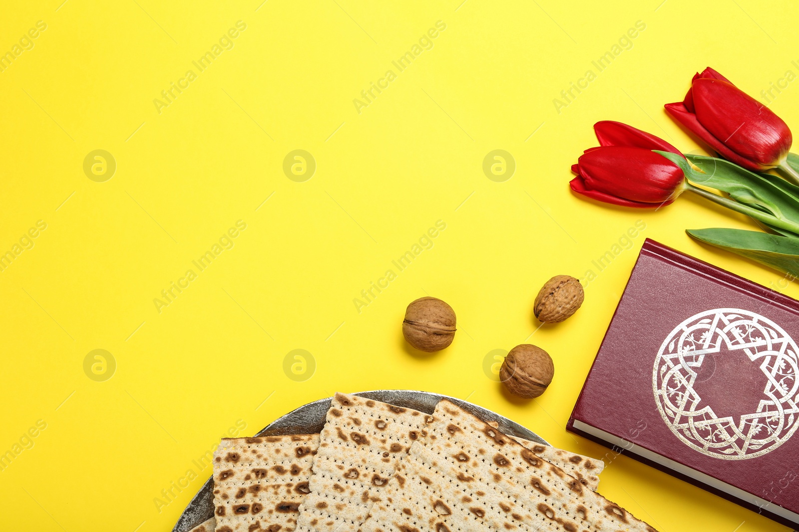 Photo of Flat lay composition with matzos on yellow background, space for text. Passover (Pesach) celebration