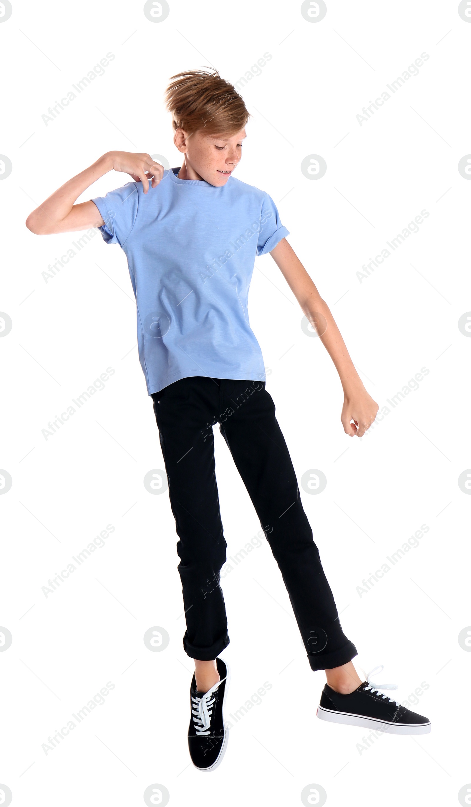 Photo of Portrait of young boy jumping on white background