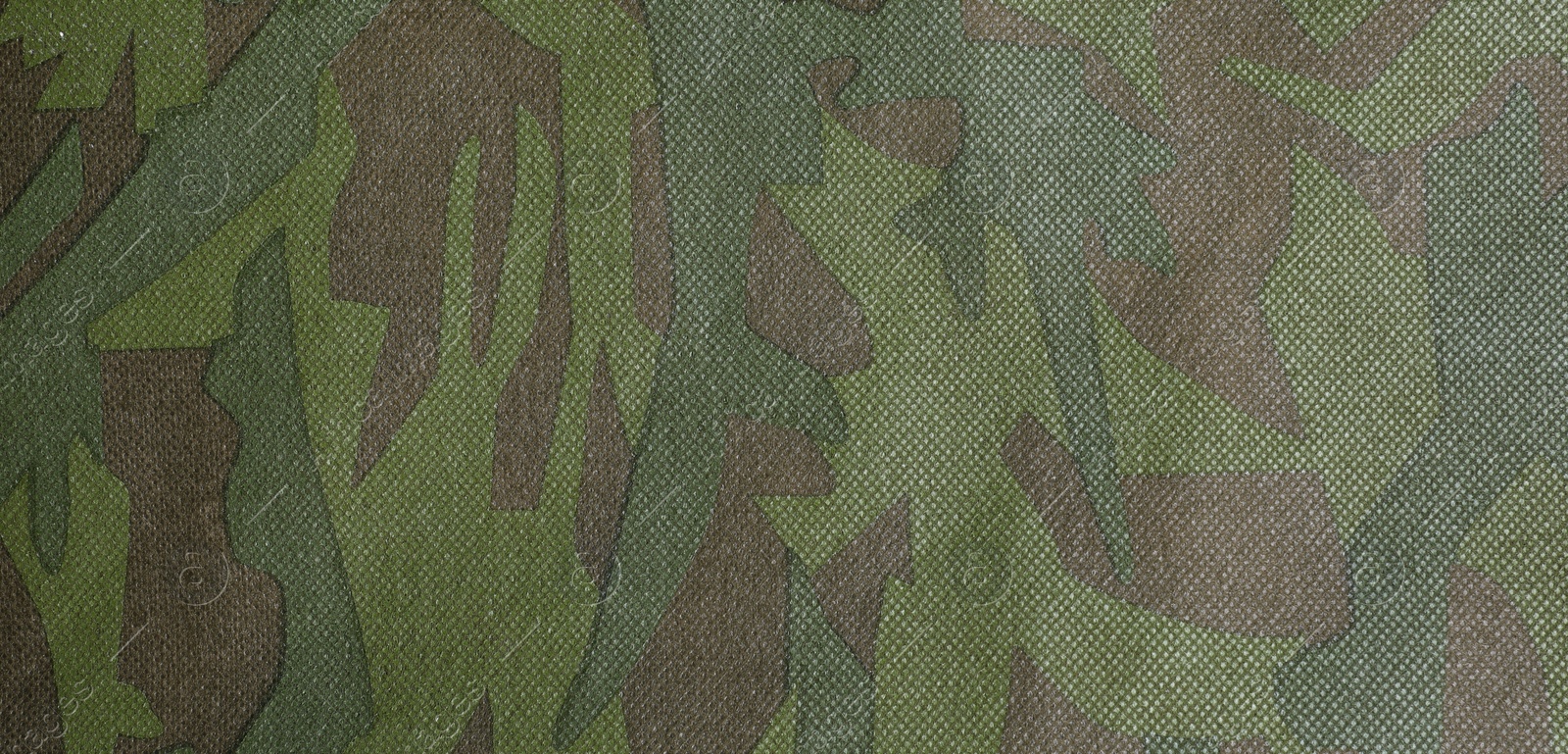 Photo of Texture of camouflage fabric as background, top view