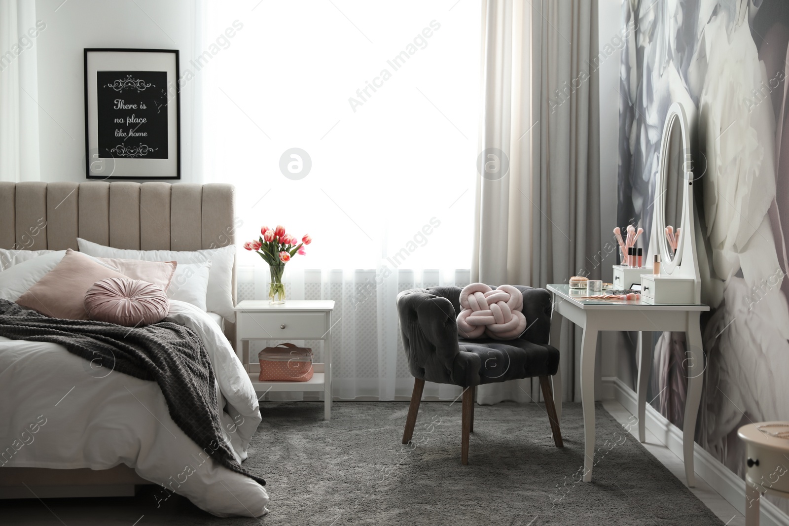 Photo of Stylish bedroom interior with elegant dressing table and floral wallpaper