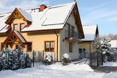 Houses and trees covered with snow in winter morning