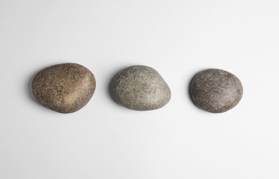 Photo of Zen stones on white background, top view