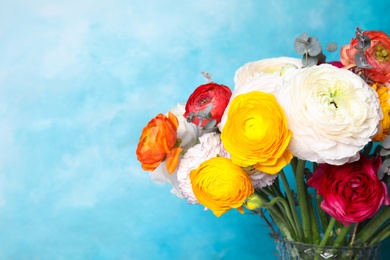 Photo of Bouquet with beautiful ranunculus flowers on color background. Space for text