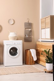 Stylish laundry room with modern washing machine. Interior design