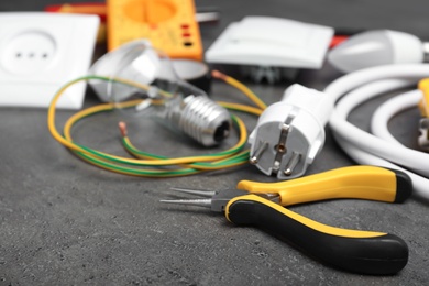 Set of electrician's tools on gray table