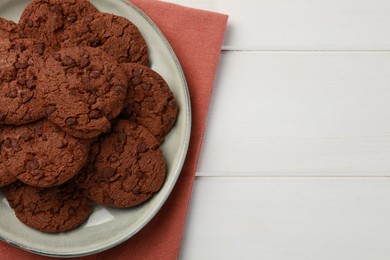 Photo of Delicious chocolate chip cookies on white wooden table, top view. Space for text