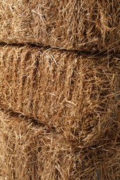 Photo of Bales of dried straw as background, closeup