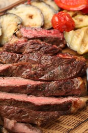 Photo of Delicious grilled beef with vegetables on table, closeup