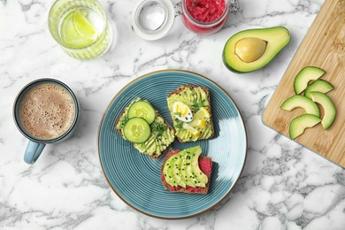 Photo of Tasty breakfast with crisp avocado  toasts on table, top view