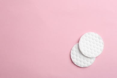 Photo of Cotton pads on color background, top view. Space for text