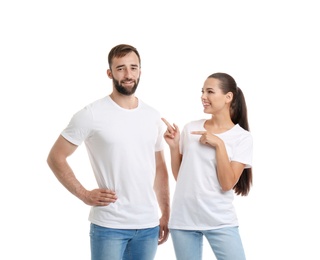 Young couple in t-shirts on white background. Mockup for design