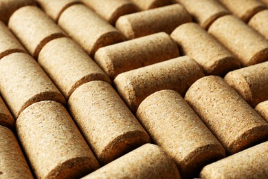 Photo of Many corks of wine bottles as background, closeup