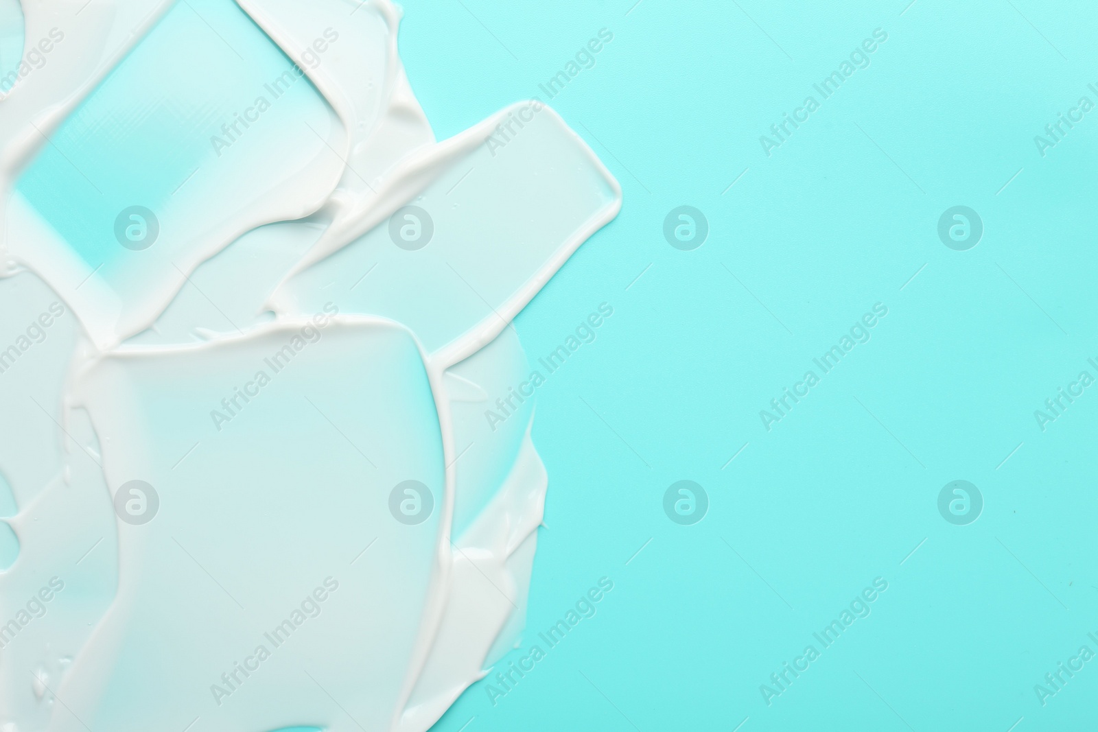 Face cream on light blue background, top view. Space for text Photo of Face cream on light blue background, top view. Space for text