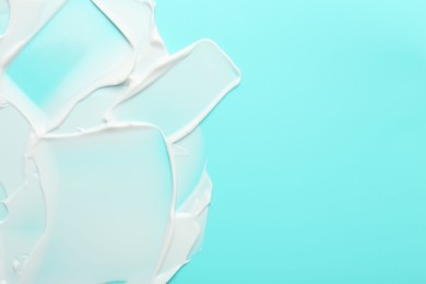 Photo of Face cream on light blue background, top view. Space for text