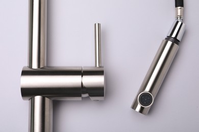 Photo of Modern pull out kitchen faucet on grey background, top view