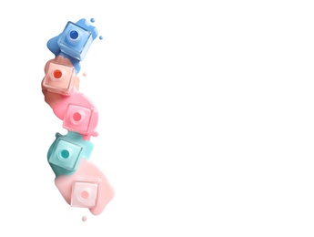 Photo of Spilled different nail polishes with bottles on white background, top view