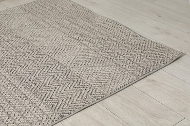 Photo of Soft grey carpet on white laminated floor indoors