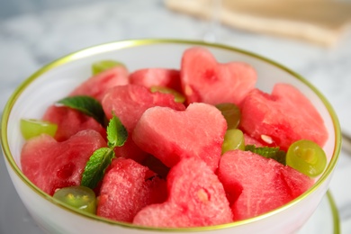 Photo of Delicious salad with watermelon in bowl, closeup