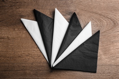 Photo of Folded clean paper tissues on wooden table, flat lay