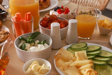 Photo of Dishes with different food on table indoors. Luxury brunch