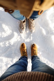 Photo of Couple standing on white snow, above view