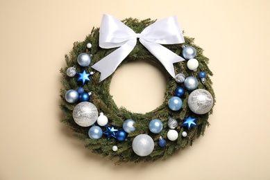 Photo of Beautiful Christmas wreath on beige background, top view