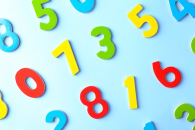 Photo of Colorful numbers on light blue background, flat lay