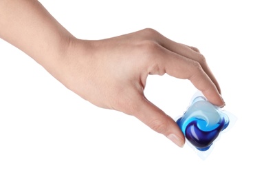 Photo of Woman holding laundry capsule on white background, closeup