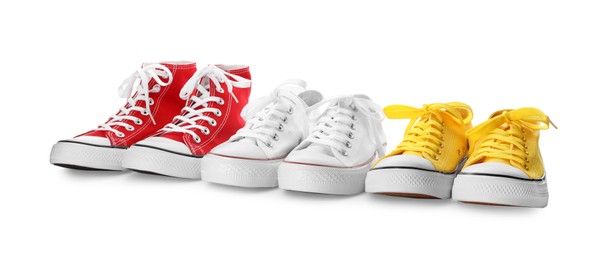 Photo of Many different sneakers on white background. Trendy shoes