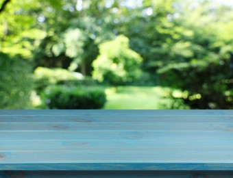 Image of Empty light blue wooden surface outdoors on sunny day. Space for design
