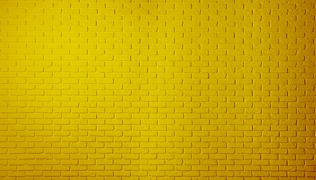 Image of Texture of golden rod color brick wall as background