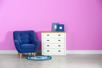 Photo of Stylish room interior with chest of drawers and space for text