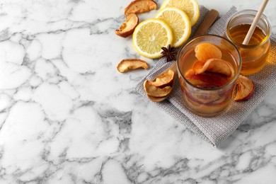 Photo of Delicious compote and ingredients on white marble table, above view. Space for text