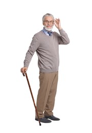 Photo of Senior man with walking cane on white background