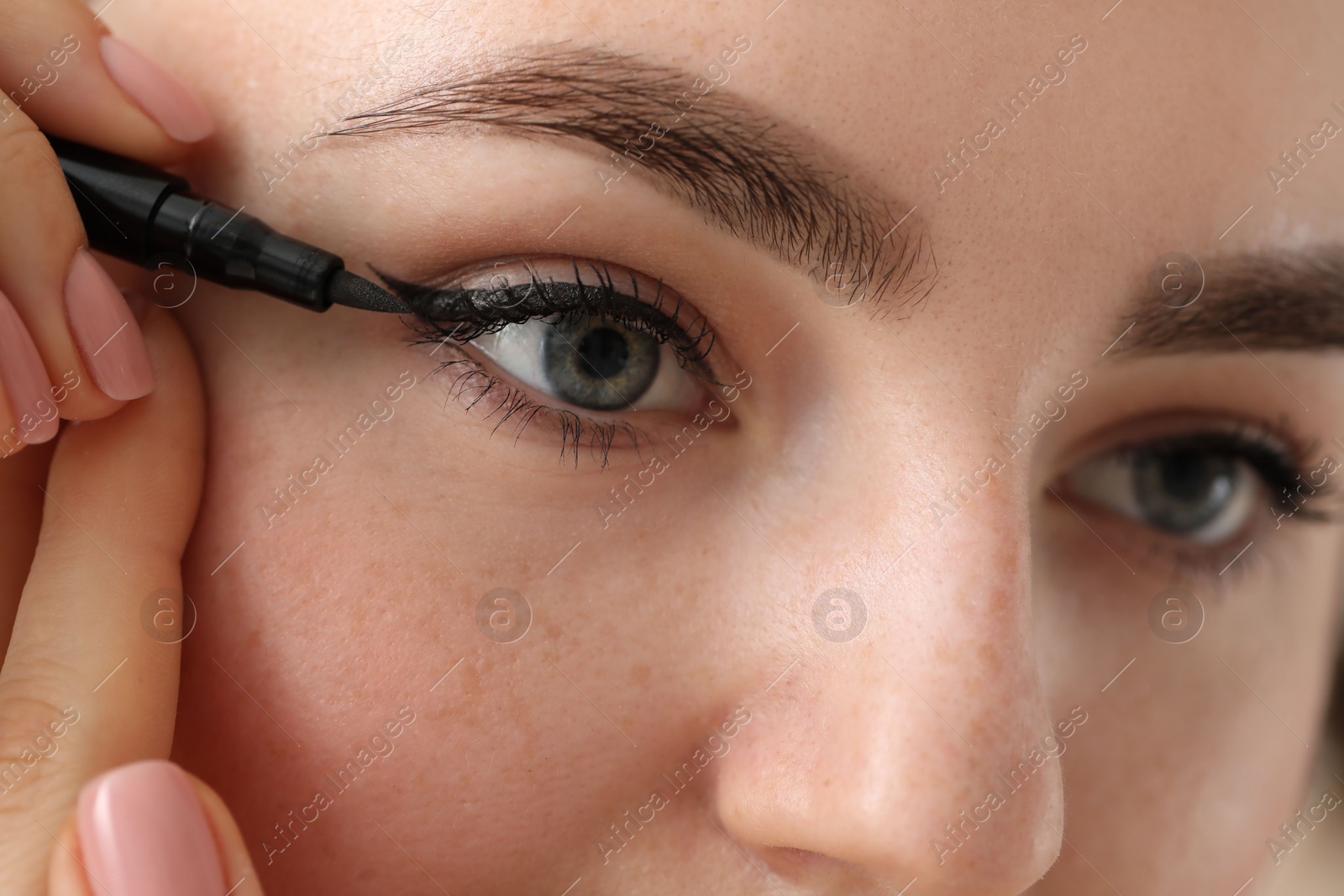 Photo of Makeup product. Woman applying black eyeliner, closeup