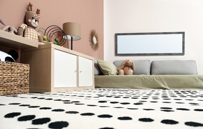 Photo of Montessori bedroom interior with floor bed and toys