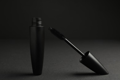 Photo of Black mascara with wand on dark background