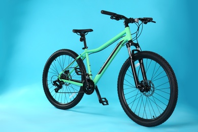 Photo of Modern bicycle on blue background. Healthy lifestyle