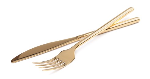 Photo of Golden fork and knife on white background